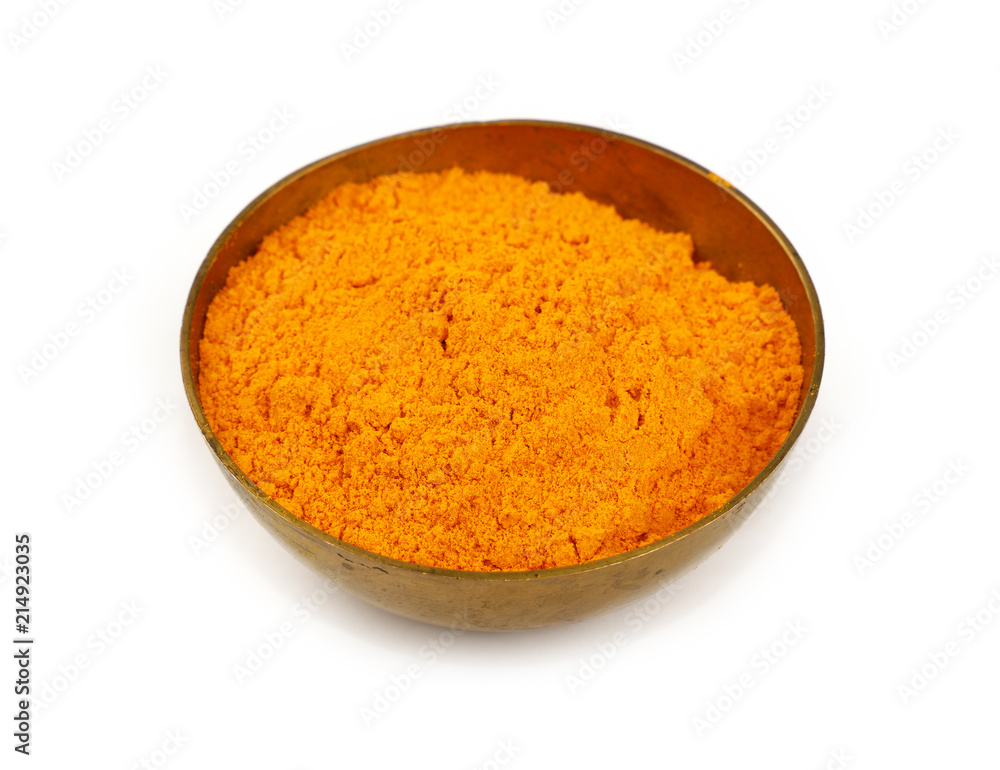 One bronze metal bowl full of yellow turmeric powder One bronze metal bowl full of yellow turmeric powder