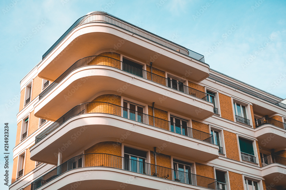 curved corner building with orange facade and white balcony curved corner building with orange facade and white balcony