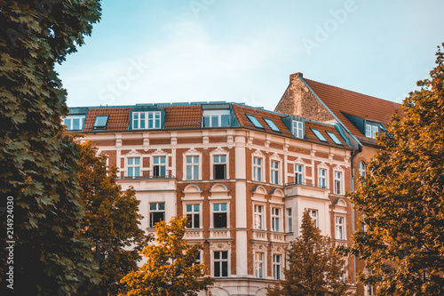 historical apartment houses at berlin framed by autumn trees