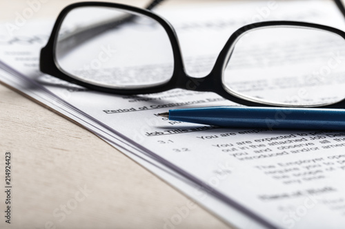 Close up shot of Eyeglasses on document papers business concept
