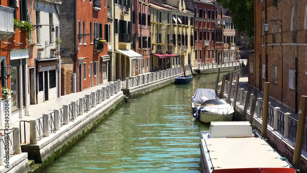 Narrow Venetian street, tourism and holidays, sunny days, boats on water