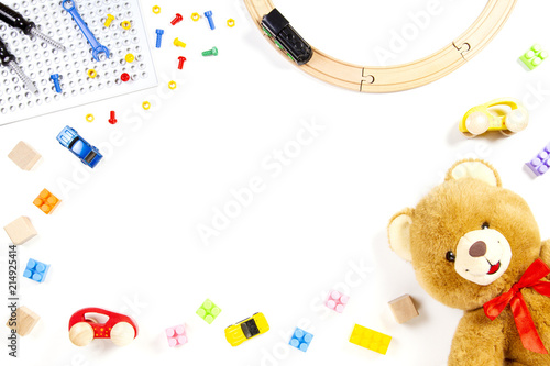 Kids toys background with teddy bear, toy train, cars and colorful bricks