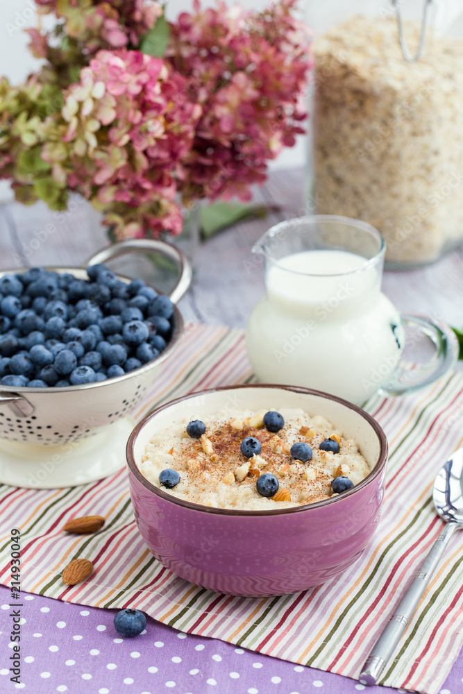 Oatmeal porridge with blueberries, almonds, cinnamon in bowl. Super food for healthy nutritious breakfast Oatmeal porridge with blueberries, almonds, cinnamon in bowl. Super food for healthy nutritious breakfast
