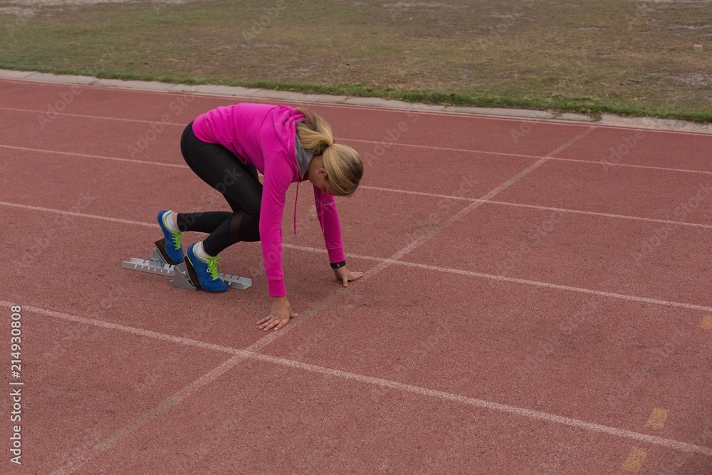 Female athletic ready for the race on the track Female athletic ready for the race on the track