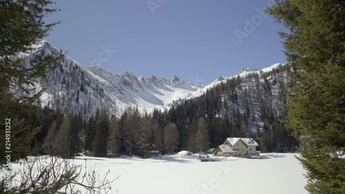 Wide view of mountain lodge in the middle of the mountain with sniow photo