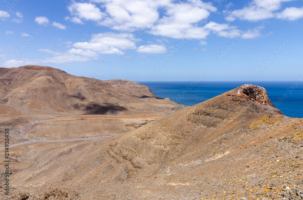 Typical landscape of Fuerteventura with barren volcanic mountains and the ocean - a view from the Entallada lighthouse terrace