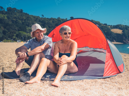 Senior couple sitting in beach shelter