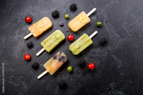 Photo of frozen juice on stick, blackberry,cherry, gooseberries