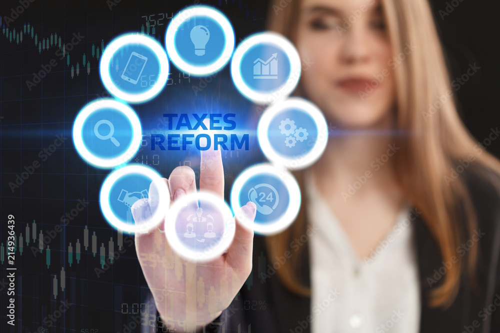 The concept of business, technology, the Internet and the network. A young entrepreneur working on a virtual screen of the future and sees the inscription: taxes reform The concept of business, technology, the Internet and the network. A young entrepreneur working on a virtual screen of the future and sees the inscription: taxes reform