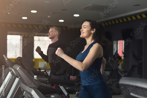 Fitness people training in gym on treadmills