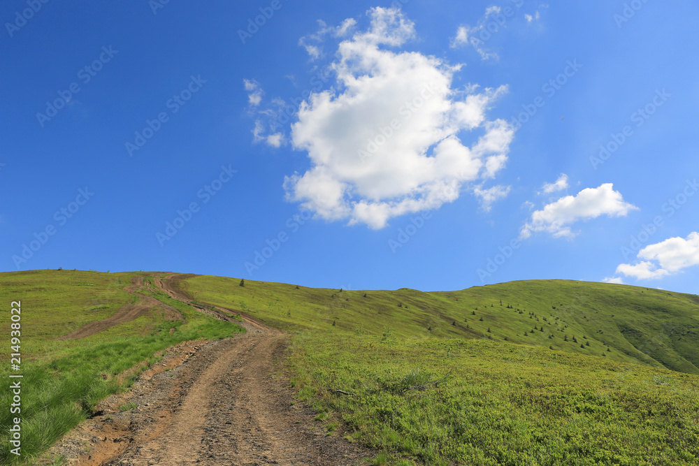 mountain road across green hill mountain road across green hill