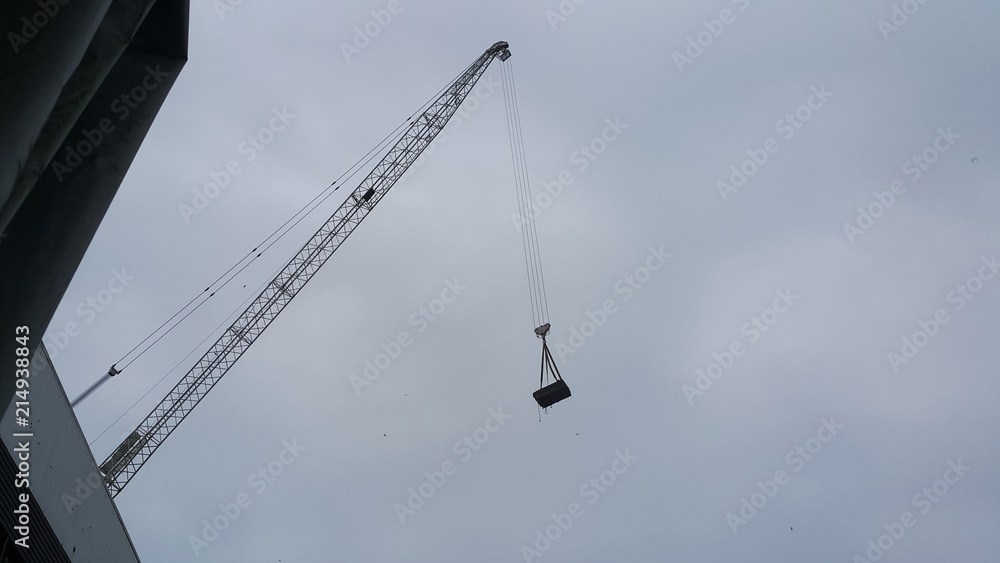 High-level construction using crane lifting material. High-level construction using crane lifting material.