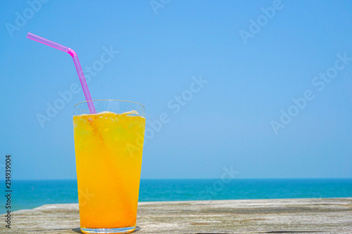 Orange juice drinking on the beach. ビーチで飲むオレンジジュース