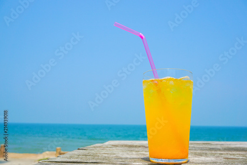 Orange juice drinking on the beach. ビーチで飲むオレンジジュース