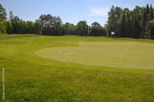 The 18th Hole. Putting green and fairway at the 18th hole on a sunny summer day.