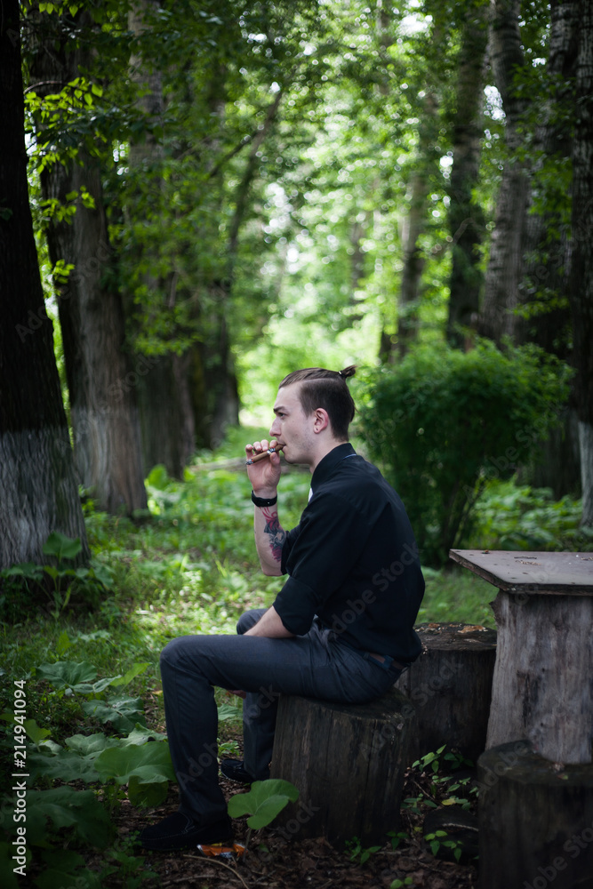 Young handsome stylish man smoking cigar Young handsome stylish man smoking cigar