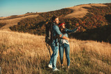 Young hikers couple with backpack on mountain enjoy on a sunny day