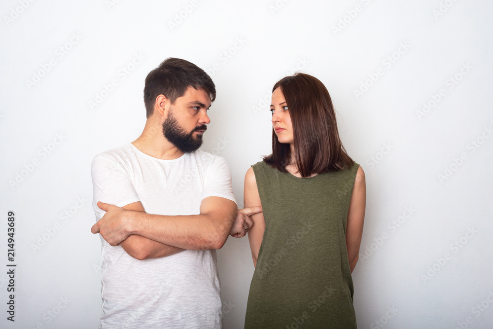 Young couple looks each to other trying to solve their problems Young couple looks each to other trying to solve their problems