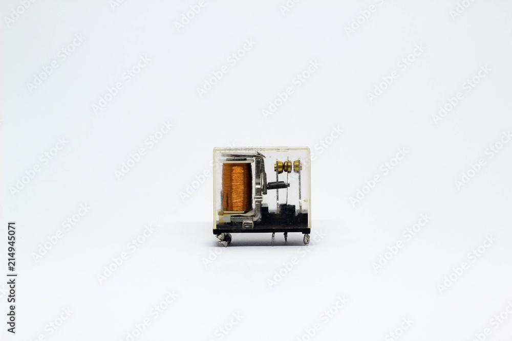 Electrical auxiliary relay in transparent plastic cases on white background.