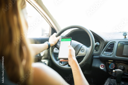 Woman using mobile navigation while driving