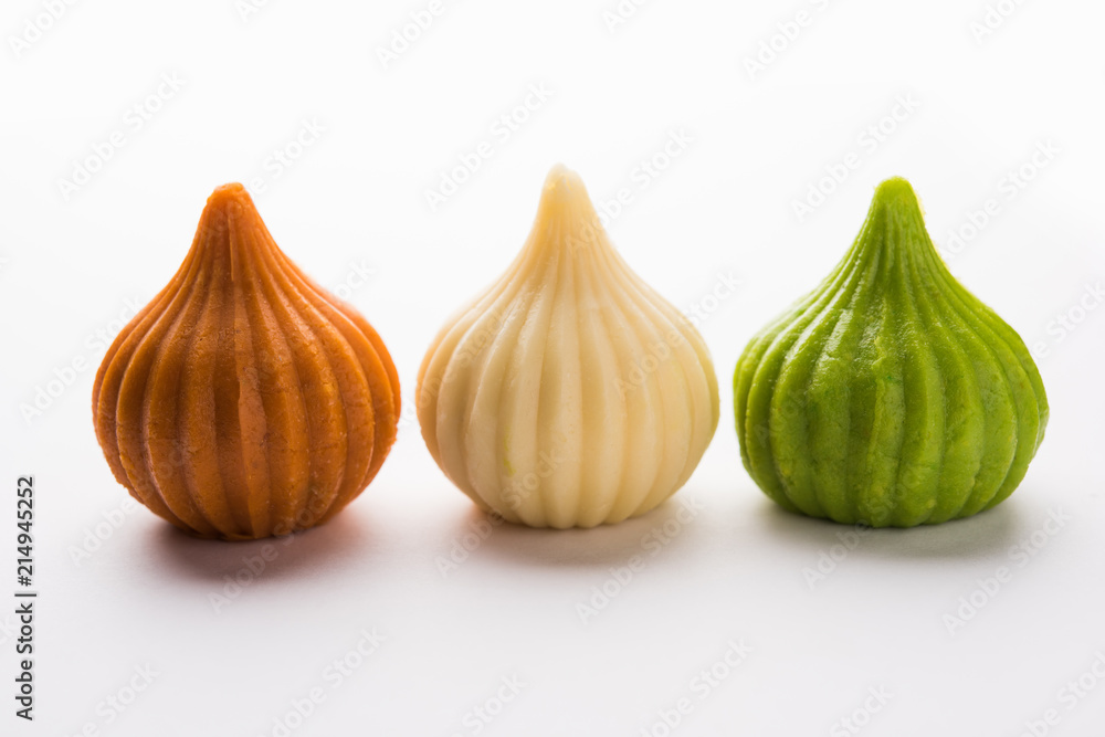 Obraz premium Sweet Tiranga coloured modak shape mithai or dumpling for Independence or republic day greeting card