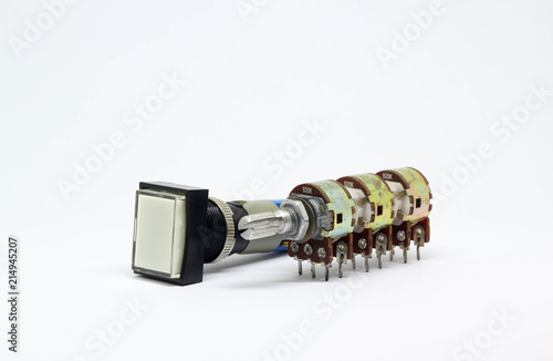 Six gangs potentiometer or variable resistor and push botton switch on white background.