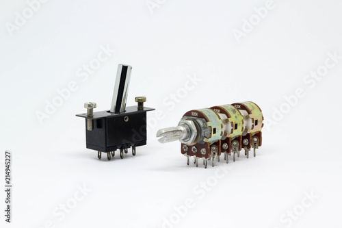 Six gangs potentiometer or variable resistor and toggle switch on white background.