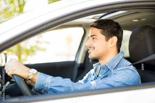 Good looking guy driving a car