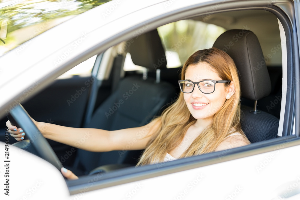 Attractive woman driving her car