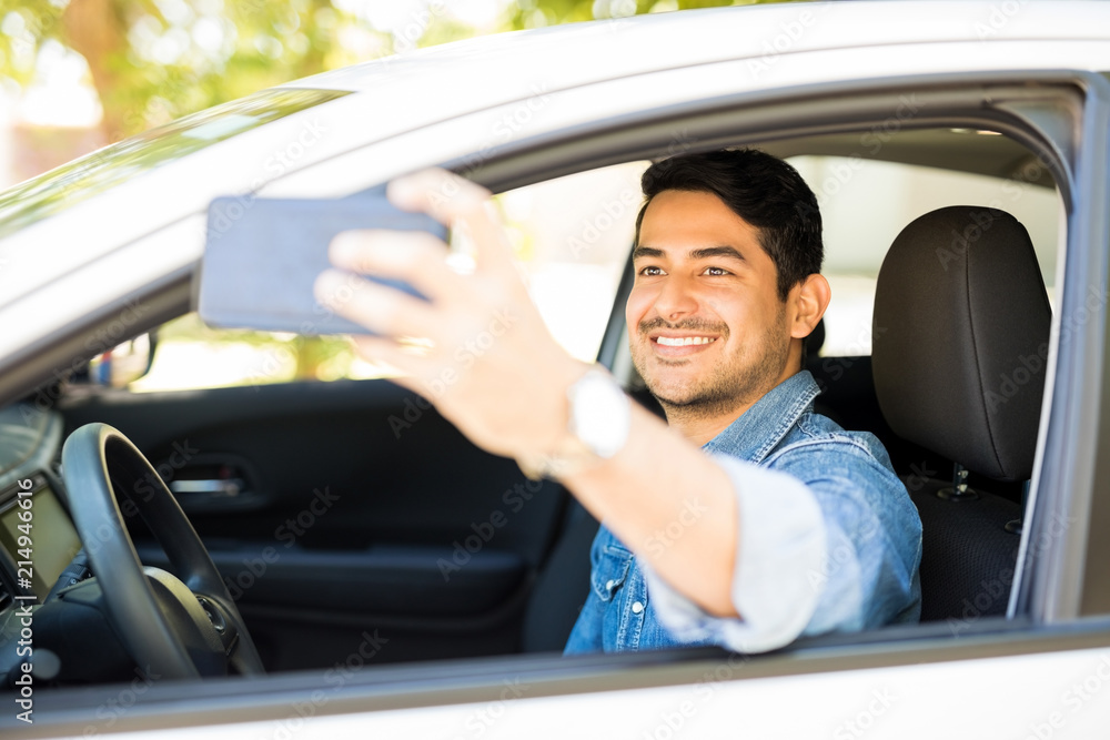 Man taking selfie in his new car Man taking selfie in his new car
