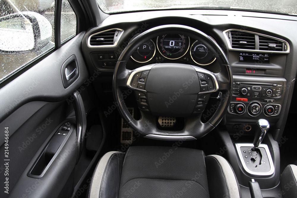 Steering wheel on the car dashboard and the driver's seat