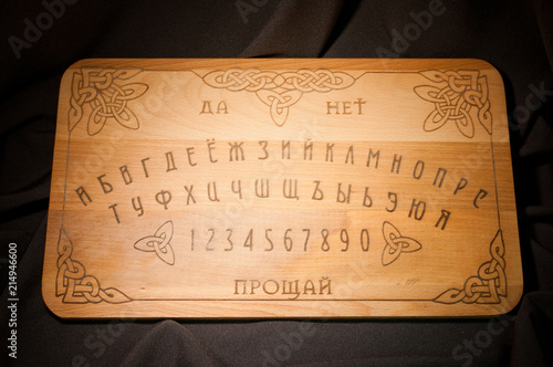 Ouija Board, yellow on a black background