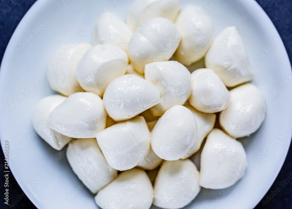 mozzarella balls in plate on black background, top view. Flat lay. Food concept. mozzarella balls in plate on black background, top view. Flat lay. Food concept.