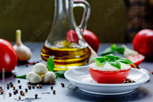 Mozzarella, red tomatoes and fresh Basil on a black background. top view. Flat lay. Food concept. Healthy and wholesome food