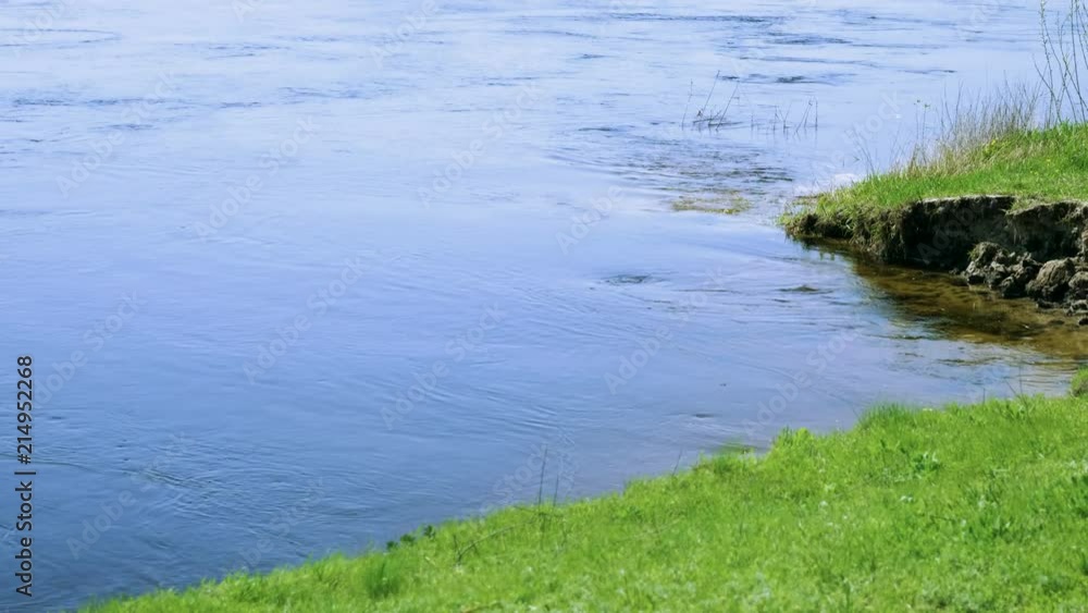 Spring landscape. Riverside. Water flowing along the shore. 4K Spring landscape. Riverside. Water flowing along the shore. 4K