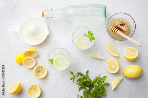 Citrus linfused emonade water with lemon sliced , healthy and detox water drink in summer on concrete table. Top view photo