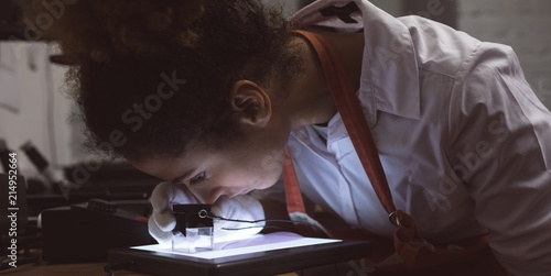 Female photographer using pocket magnifier