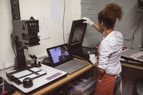 Female photographer using photo scanner