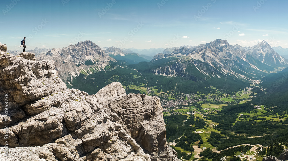 Via ferrata Tofana di Mezzo climbers on the ridge in the Dolomites, Group of climbers on the mountain top, Dolomite Alps, Italy. Silhouette of people climbing the mountain. Tiny Man Big Landscape