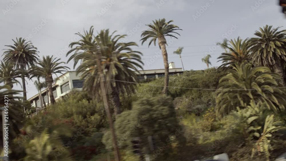 Dynamic Wide shot of Building in Malibu - from moving car hot sunny day Dynamic Wide shot of Building in Malibu - from moving car hot sunny day