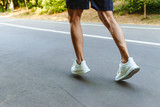 Back view of muscular sportsman legs jogging