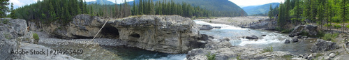 panorama picture with a river and a cave