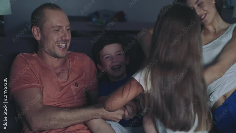 Family Is Watching TV In The Evening. Family Is Watching TV In The Evening.