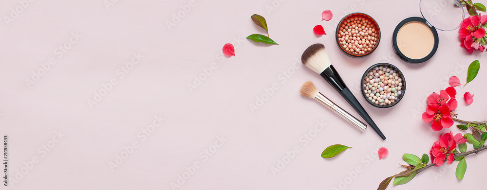 Various cosmetic products for make-up with red flowers on a pink background with copy space long banner. Makeup Accessories Top view Flat Lay. Powder Rouge Eyeshadow Corrector Brushes Various cosmetic products for make-up with red flowers on a pink background with copy space long banner. Makeup Accessories Top view Flat Lay. Powder Rouge Eyeshadow Corrector Brushes