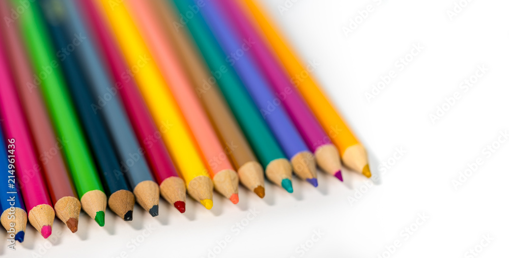 Close up of row of colorful drawing pencils against white