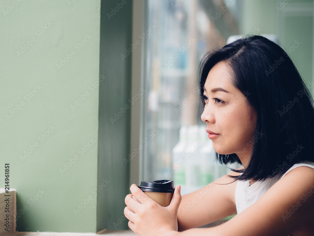 Woman is drinking hot cup of coffee in the cafe. Woman is drinking hot cup of coffee in the cafe.