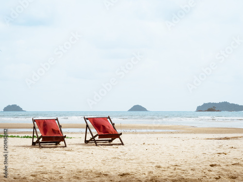 Fototapeta Naklejka Na Ścianę i Meble -  Red beach beds on summer beach.