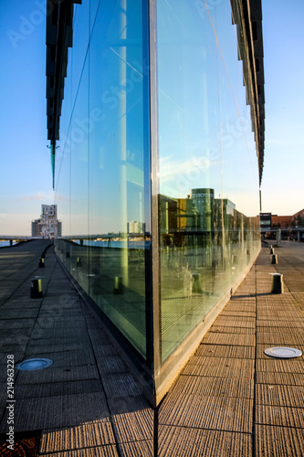 Symmetric reflection of the city in the corner of a building photo