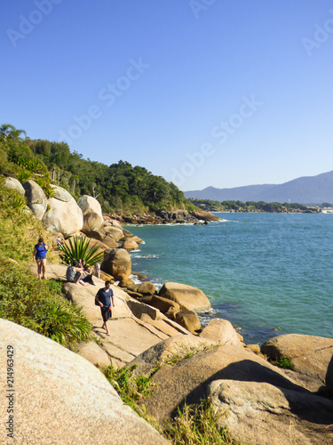 Florianopolis, Brazil - Circa July 2018: People enjoying the sun at the Natural pools of Barra da Lagoa photo