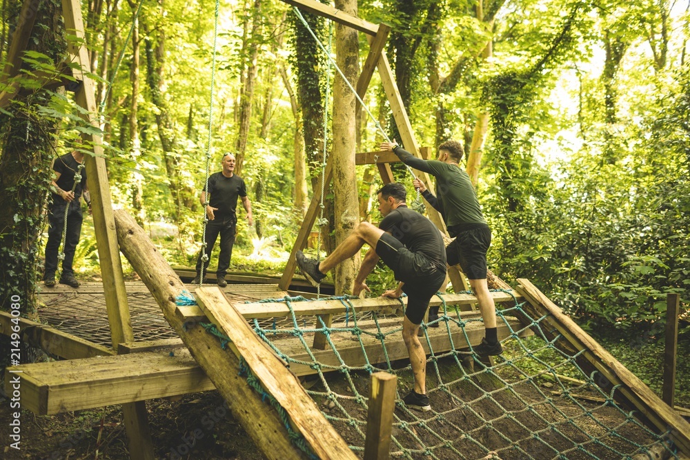 Fit mens training over obstacle course Fit mens training over obstacle course